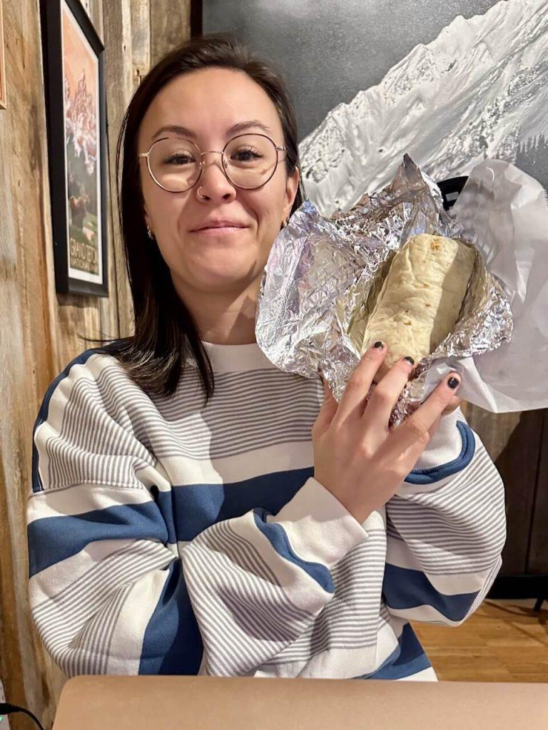 Jackie showing off her breakfast burrito at the Red Moose Cafe