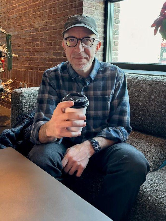 Dad sipping his latte on the couch at the Sunroom coffee shop.