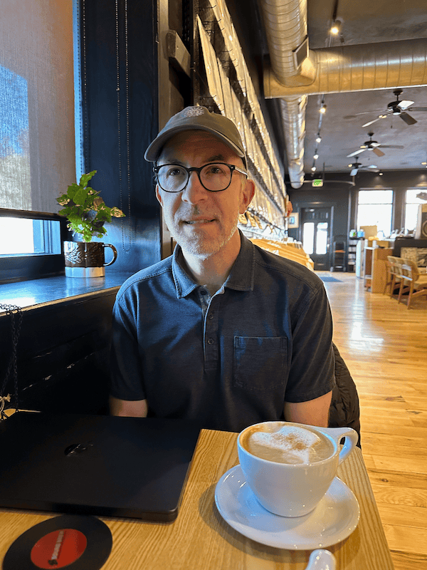 Dad sitting at a table at the sound brew coffee lounge.