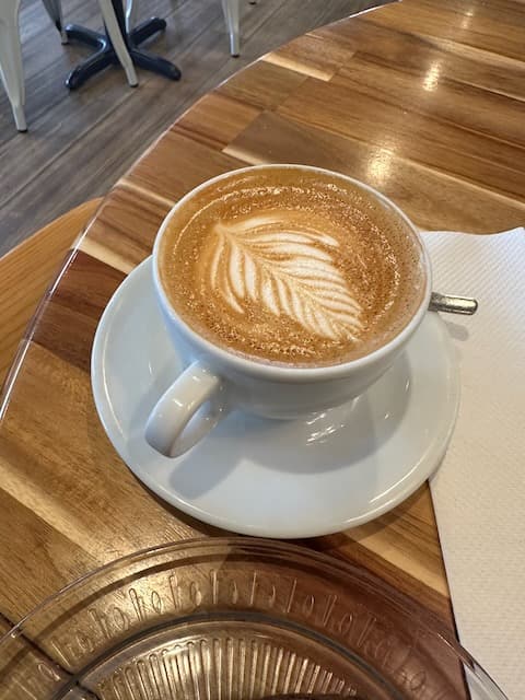 white ceramic mug with latte art.