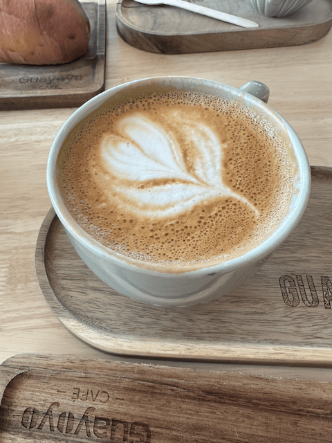 A Dark Latte served in a ceramic mug with latte art.