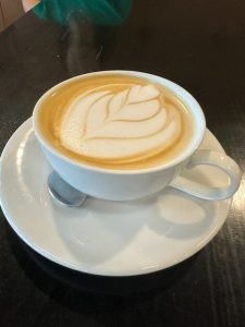 A whole-milk flat white with expert latte art at Cupla Coffee.