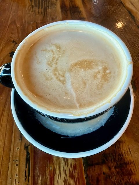 A flat white in a ceramic mug at Alpha Coffee.